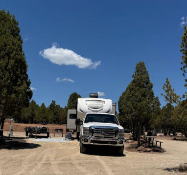 An rv site with a truck and a fifth wheel camper at Soda Creek Campground in Soda Springs, Idaho
